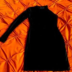 Short black dress by Naked Wardrobe. Asymmetrical body shaper built in